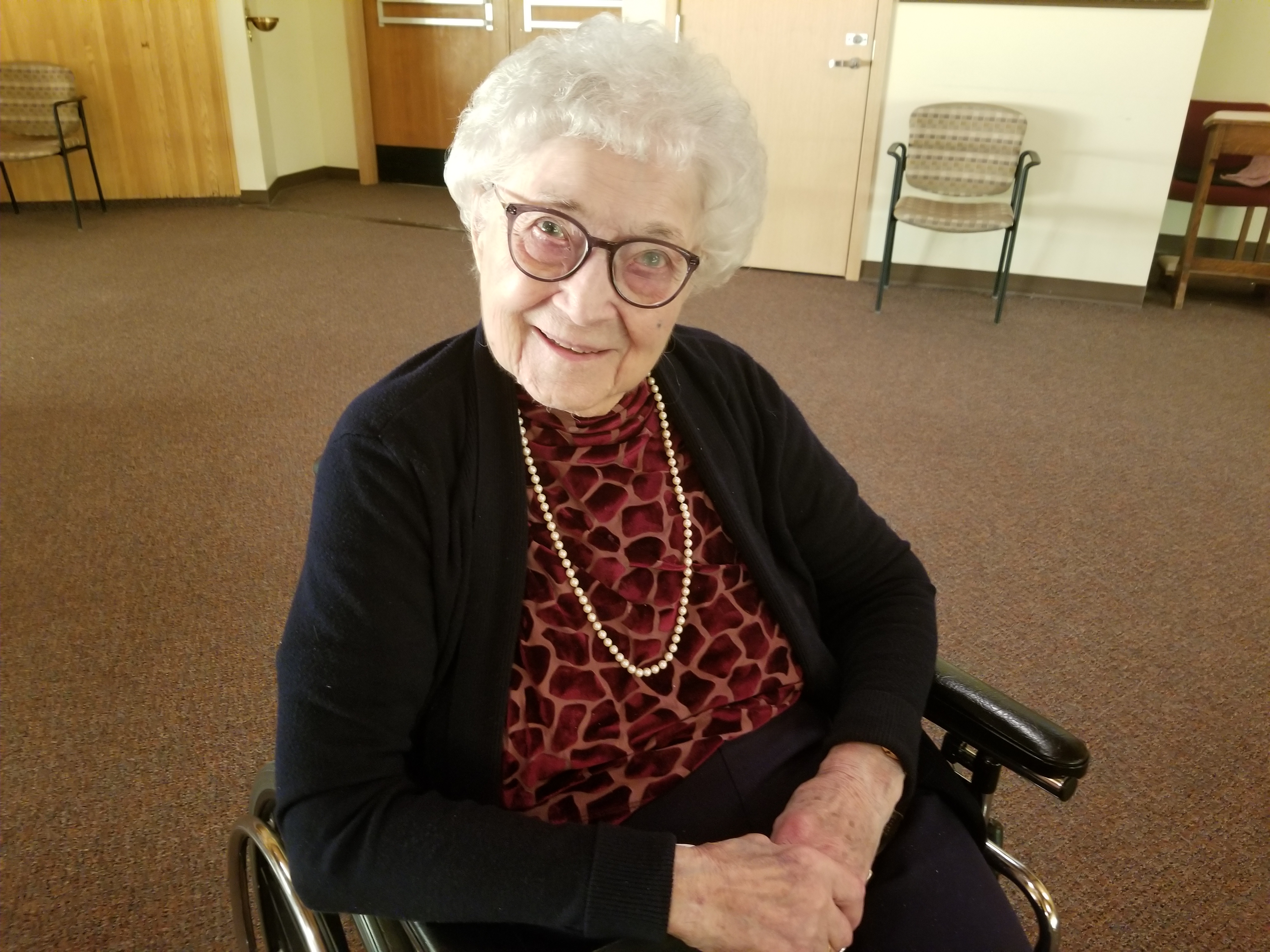 An elderly woman in a wheelchair